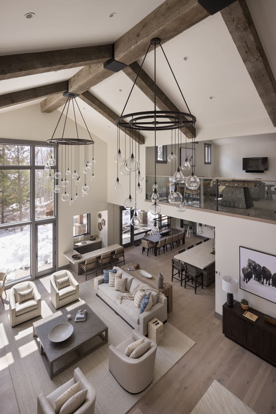 A loft view of the open concept Holly Haven Residence showcasing the living space, kitchen and the TV room above the kitchen