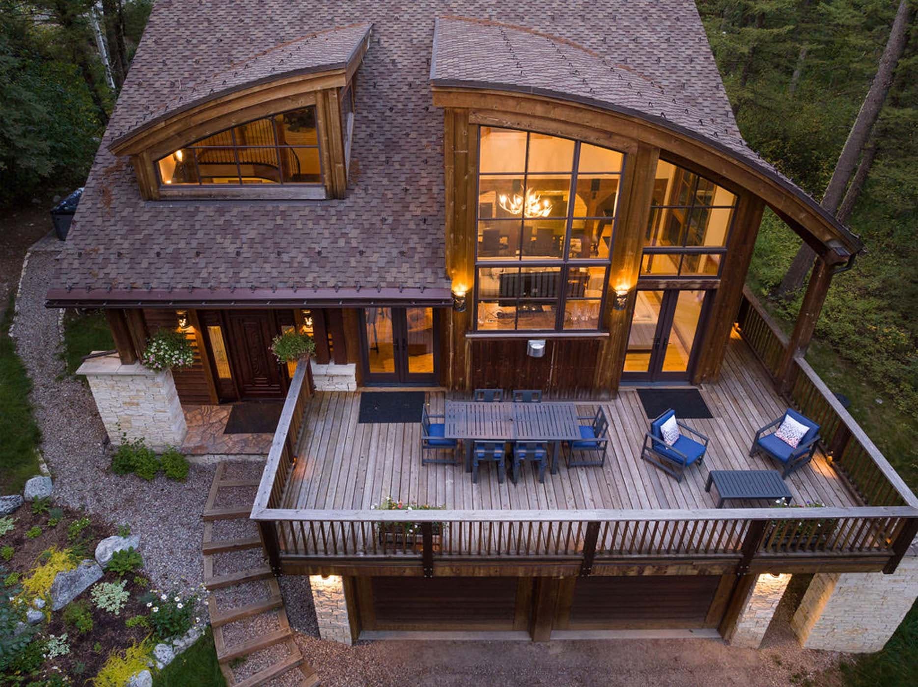Top view of the deck and living space of teh Blue Moose Lodge from the outside int eh evening