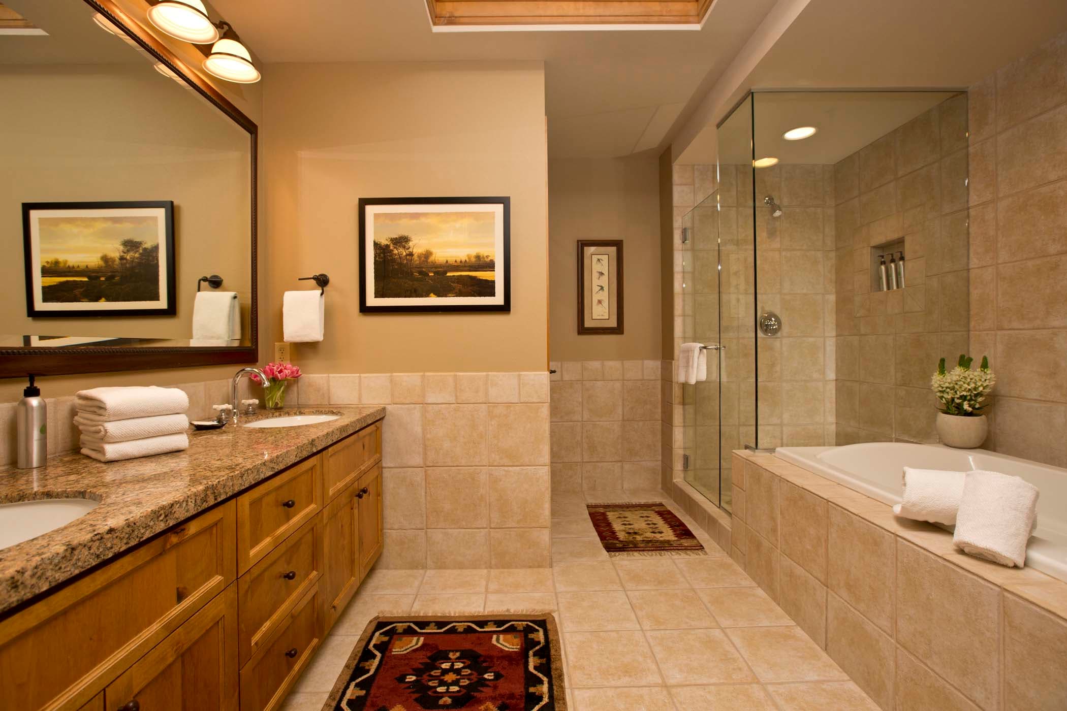 A Paintbrush master bath with dual sinks, a separate shower and tub at Teton Private residences
