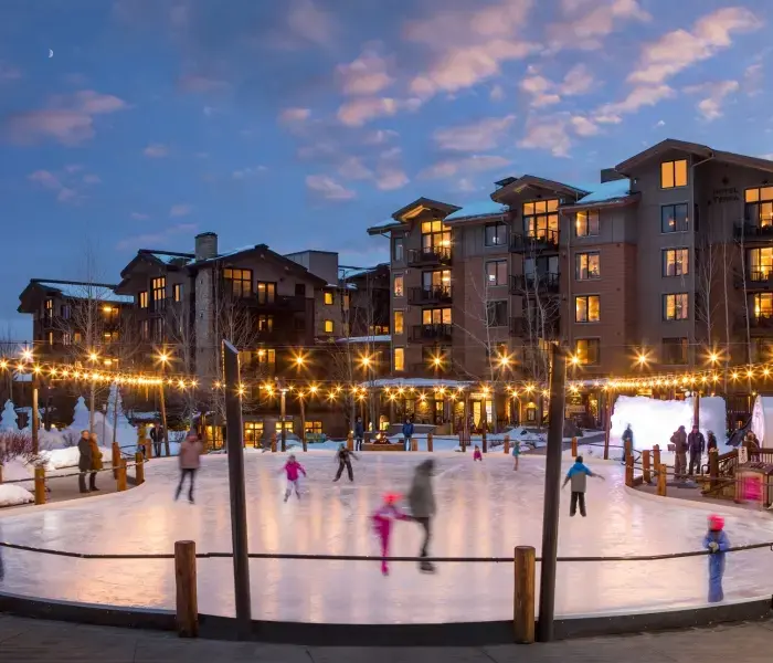 A wide view of the ice skating rink in front of Hotel Terra Mountain Resort in Teton Village, Wyoming.