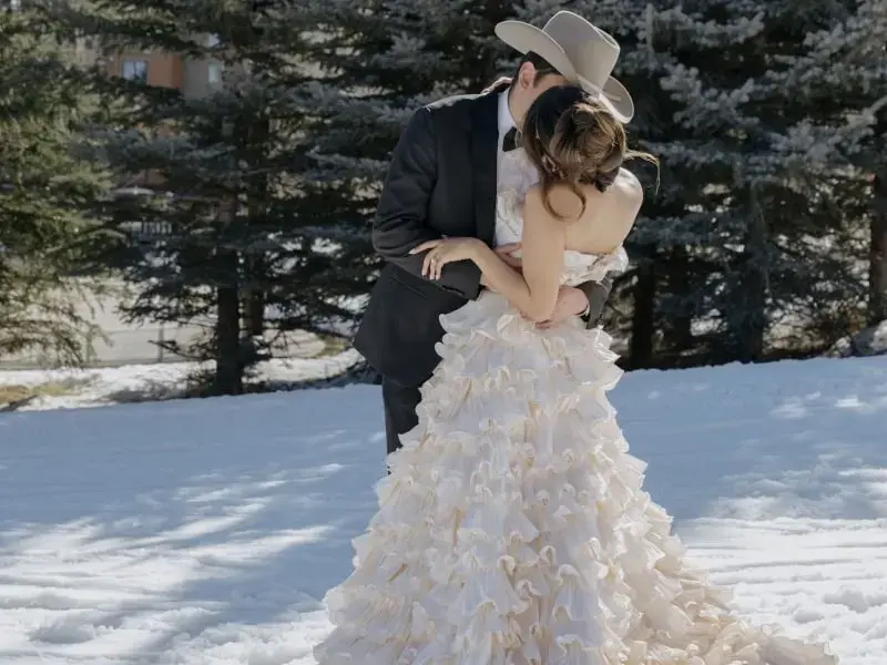 A wedding couple embracing in the snow at Teton Mountain Lodge