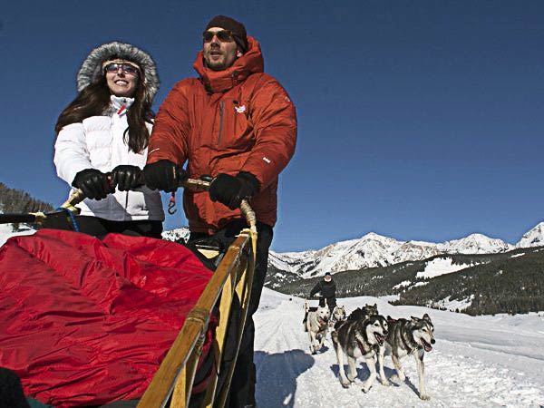 Couple dog sledding. Couple dog sledding.